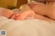 A woman laying on top of a bed with her feet up.