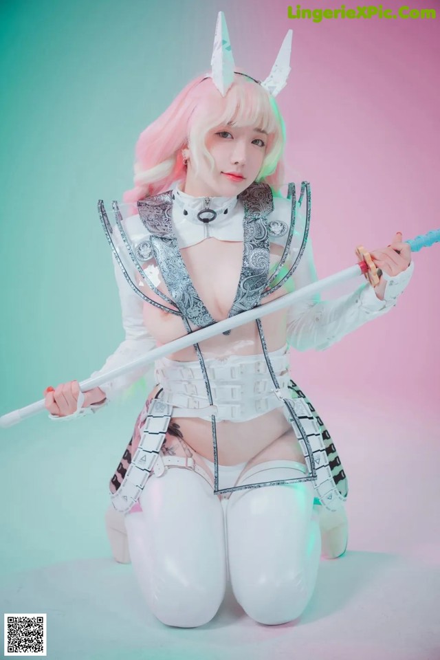 A woman in a white outfit holding a sword.