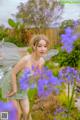 A woman in a fairy costume standing in a field of flowers.