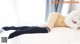 A woman laying on top of a white bed.