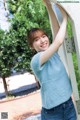 A woman leaning against a wall with her hands on the wall.