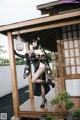 A woman in a black and white kimono posing for a picture.